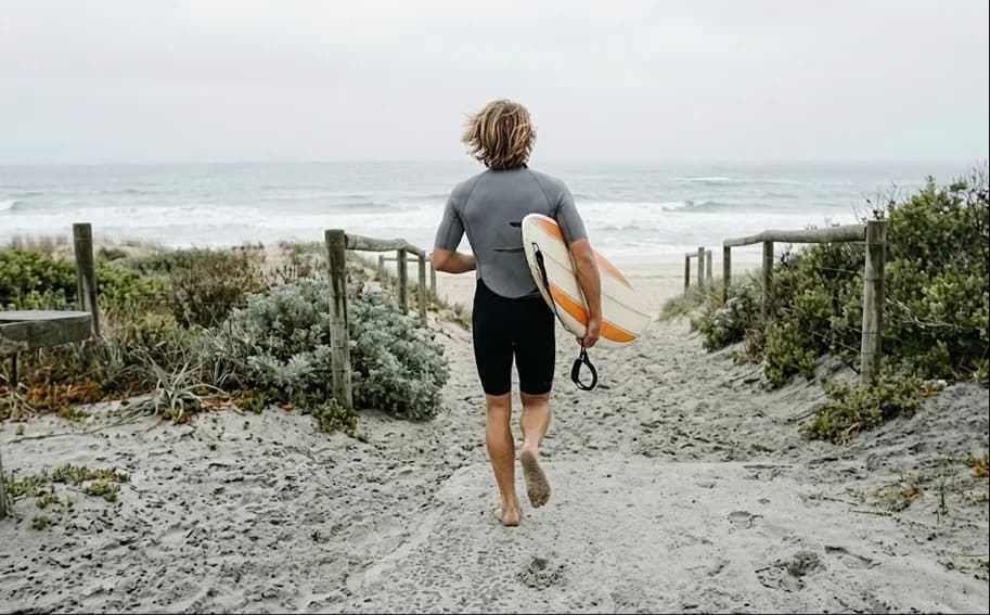 Surfer walking to the beach